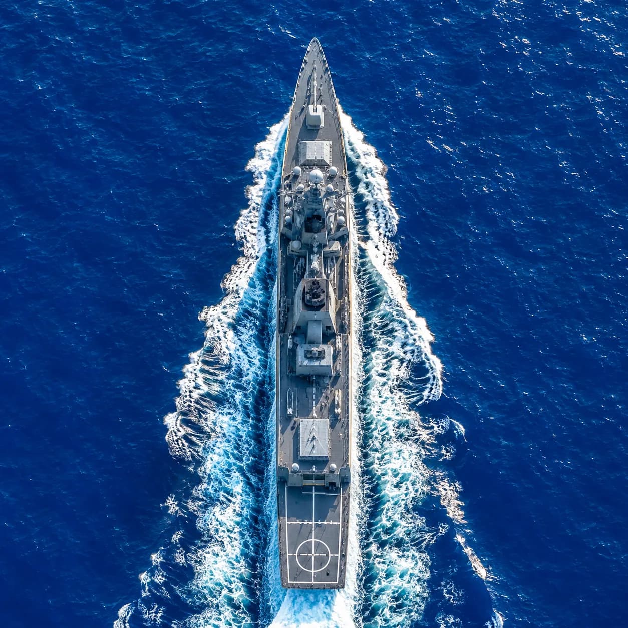 Naval ship underway at sea, viewed from above